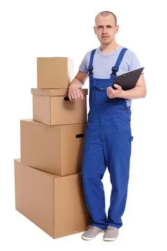 Full length portrait of loader man with heap of boxes and clipboard isolated  库存照片