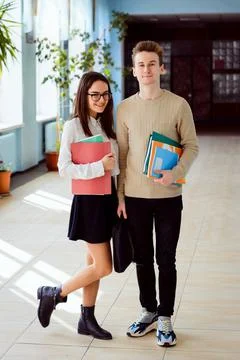 Full-length portrait of smiling students with books Stock Photos