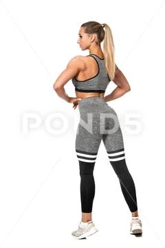 A full length portrait of a sporty young woman posing over the white backgrou Stock Photos