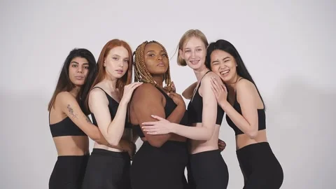 Full-length portrait of young diverse models hugging each other. Video stock 146363466