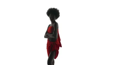 Full length shot of an African dancer wrapped in red cloth dancing, sensually Stock Footage 132882689