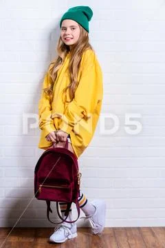 A full length shot of a bright emotional girl. Fashion for active kids. Stock Photos