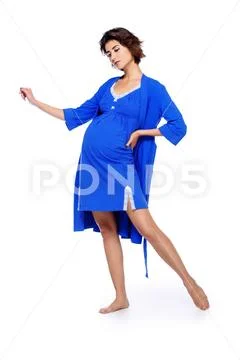 A full length shot of a pregnant charming lady in studio. Fashion concept. Mo Stock Photos