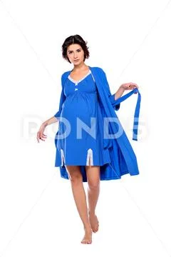 A full length shot of a pregnant charming lady in studio. Fashion concept. Mo Stock Photos