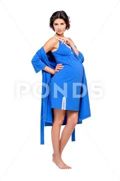 A full length shot of a pregnant charming lady in studio. Fashion concept. Mo Stock Photos