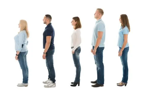 Full length side view of men and women standing in queue isolated on white ba Foto stock