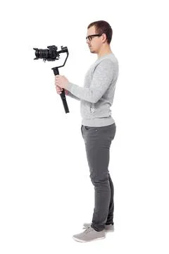 Full length side view of professional videographer using dslr camera on gimba Stockfoto's