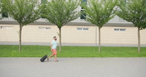 Full-length side view of the young afro-american tourist in t-shirt and shorts Stock Footage 205909505