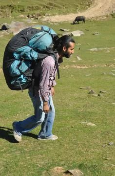 Full length side view of a young man walking in the mountain Stock Photos