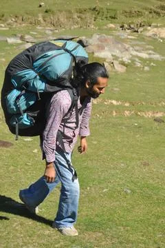 Full length side view of a young man walking in the mountain Stock Photos