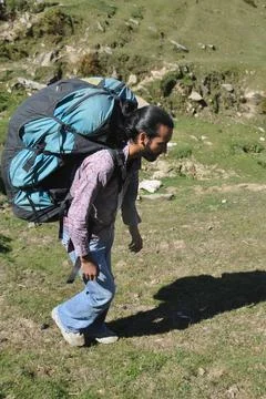 Full length side view of a young man walking in the mountain Stock Photos
