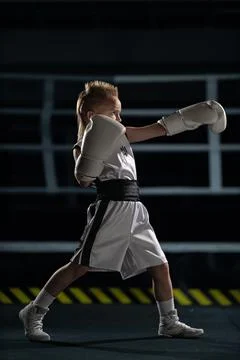 Full length side view of a young male child boxer with a mohawk hairstyle wea Stock Photos