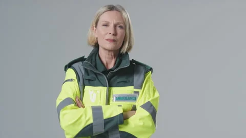 Full Length Studio Portrait Of Serious Mature Female Paramedic Against Plain Stock-Footage 152453304