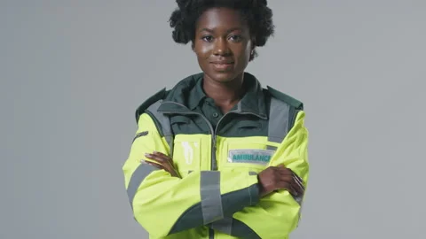 Full Length Studio Portrait Of Smiling Young Female Paramedic In Uniform Against Stock Footage 152460015