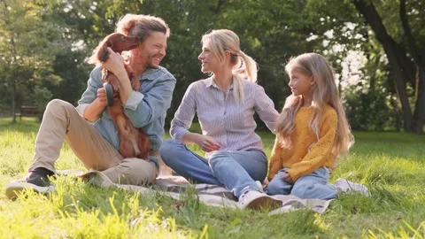Full length view of the happy man holding at the hand cute dachshund dog while Stock Footage 166446925