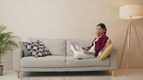 Full length view of relaxed happy indian woman drinking wine Stock Footage 240284260