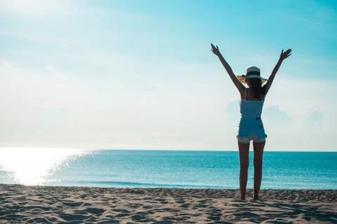 Full Length Of Woman With Arms Outstretched Standing On Shore At Beach Stock Photos