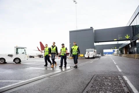 Full Length Of Workers Walking Together On Runway 写真素材