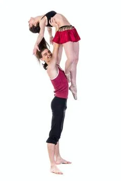 Full length of young ballet couple dancing on white background Stock Photos