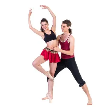 Full length of young ballet couple dancing on white background Stock Photos