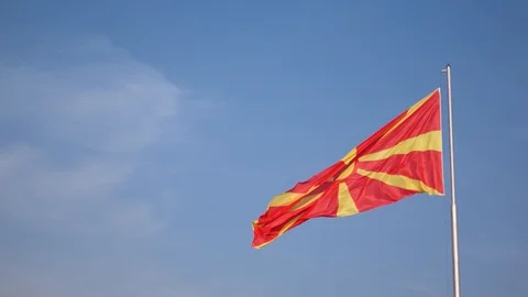Full mast Macedonia flag flapping in the wind against clean blue sky. Stock Footage 93561663