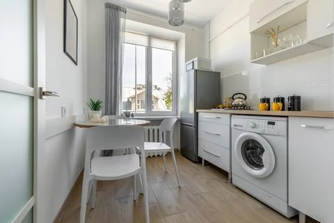 Full Modern Kitchen with Dining Area and Window Light Stock Photos