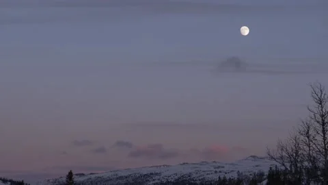 Full moon above snowy mountan top in Norway Stock Footage 140108643