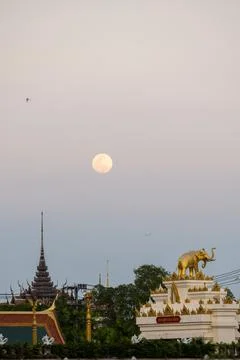 Full moon above temple rooftops and skyline Bangkok Thailand Foto stock