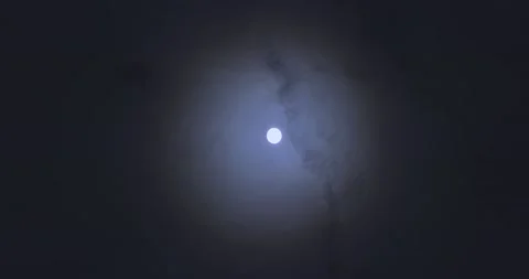 Full moon against the background of clouds floating in the sky. Bright moon in 库存影片 231491973