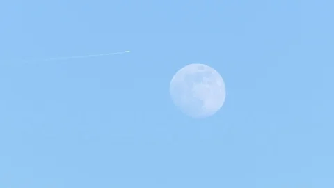 Full moon - an airplane moves over the evening sky Stock Footage 106632700