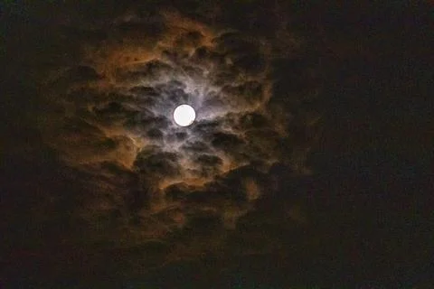Full moon among clouds in the sky. Full moon, eclipse, Halloween Fotos Stock