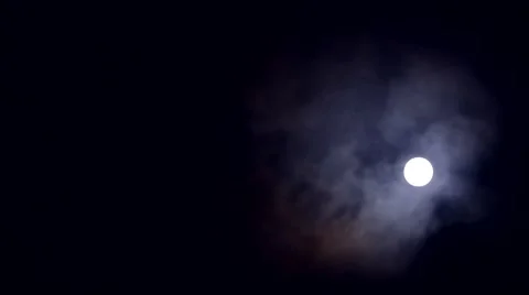 Full moon among dense clouds against a black sky 스톡 동영상 45677443