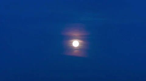 Full moon and clouds moving across the night sky Stock Footage