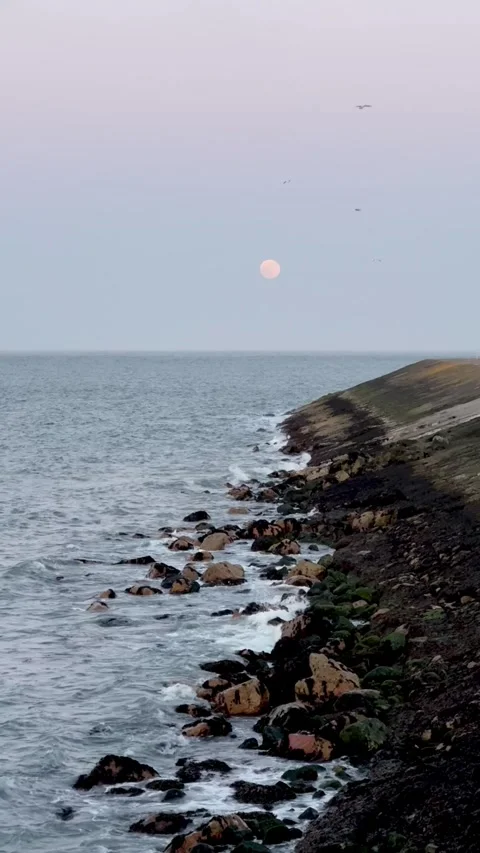Full moon and ocean waves crashing on rocks, Dublin, Ireland Stock Footage 315643718