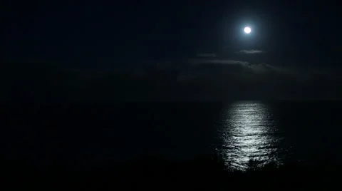 FULL MOON AND REFLECTED MOONLIGHT ON OCEAN OR LAKE Stock Footage 59072145