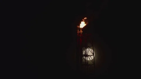 Full Moon behid the rig with gas flaring Stock Footage 84054462