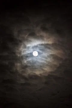 Full moon behind cloudy night sky Stock Photos