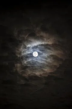 Full moon behind swirling clouds Fotos de archivo