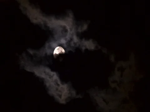 Full moon between clouds - time lapse warm light Stock Footage