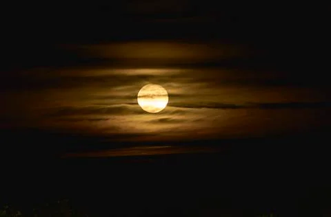 Full moon between yellow clouds Stock Photos