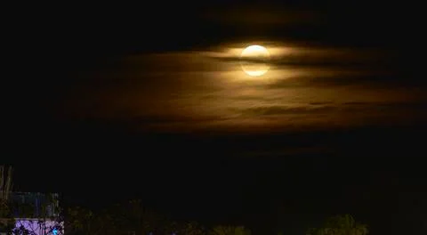 Full moon between yellow clouds Stock Photos
