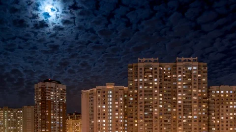 Full moon in the clouds above the city. Time lapse 4k, 3840x2160. Vídeos de archivo 103414648
