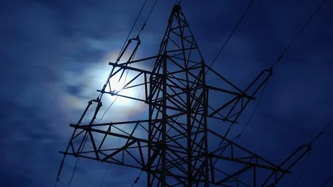 Full moon in clouds are moving behind the top of high voltage power pylon Stock Footage 106311622