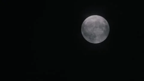 Full Moon in clouds at night movement with clouds that blow winds during a storm Stock Footage 144107135