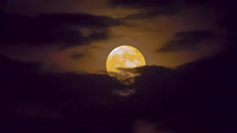 Full moon in the clouds in the night sky Stock Footage 151425237