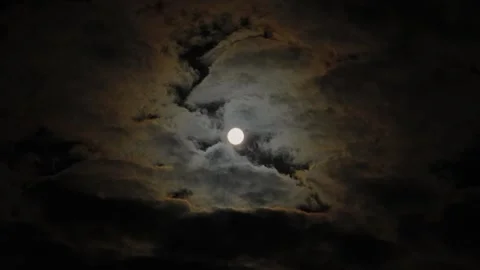A full moon in a cloudy night sky, an eerie feeling of mysticism. 動画素材 345654609