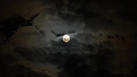 A full moon in a cloudy night sky, an eerie feeling of mysticism. 動画素材 345654629