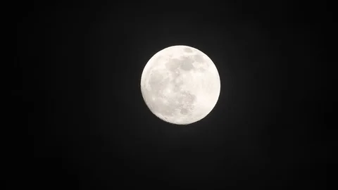 Full moon on dark cloudy night. Clouds passing by the moon, real time shot. Stock Footage 122693352