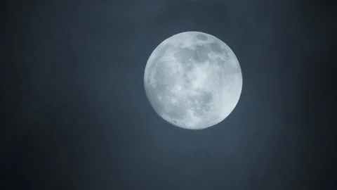 Full moon on dark cloudy night. Clouds passing by the moon, real time shot. Video stock 122693537