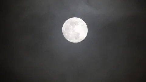 Full moon on dark cloudy night. Clouds passing by the moon, real time shot. Stock Footage 122694328